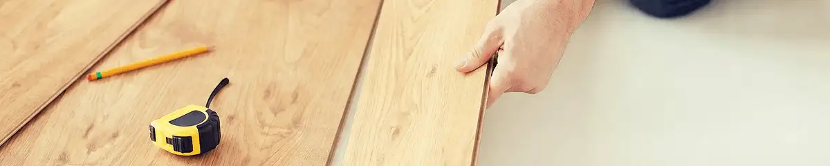 A professional installing wood flooring in Rockford, IL