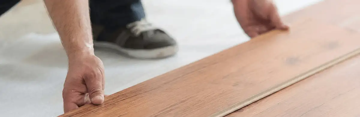 A professional installing laminate flooring in Rockford, IL